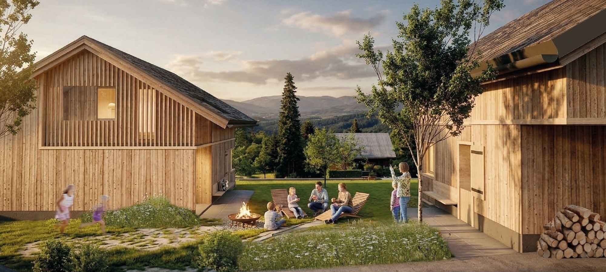 Familie am Lagerfeuer zwischen Ferienchalets aus Holz bei Sonnenuntergang mit Bergblick, Bazora