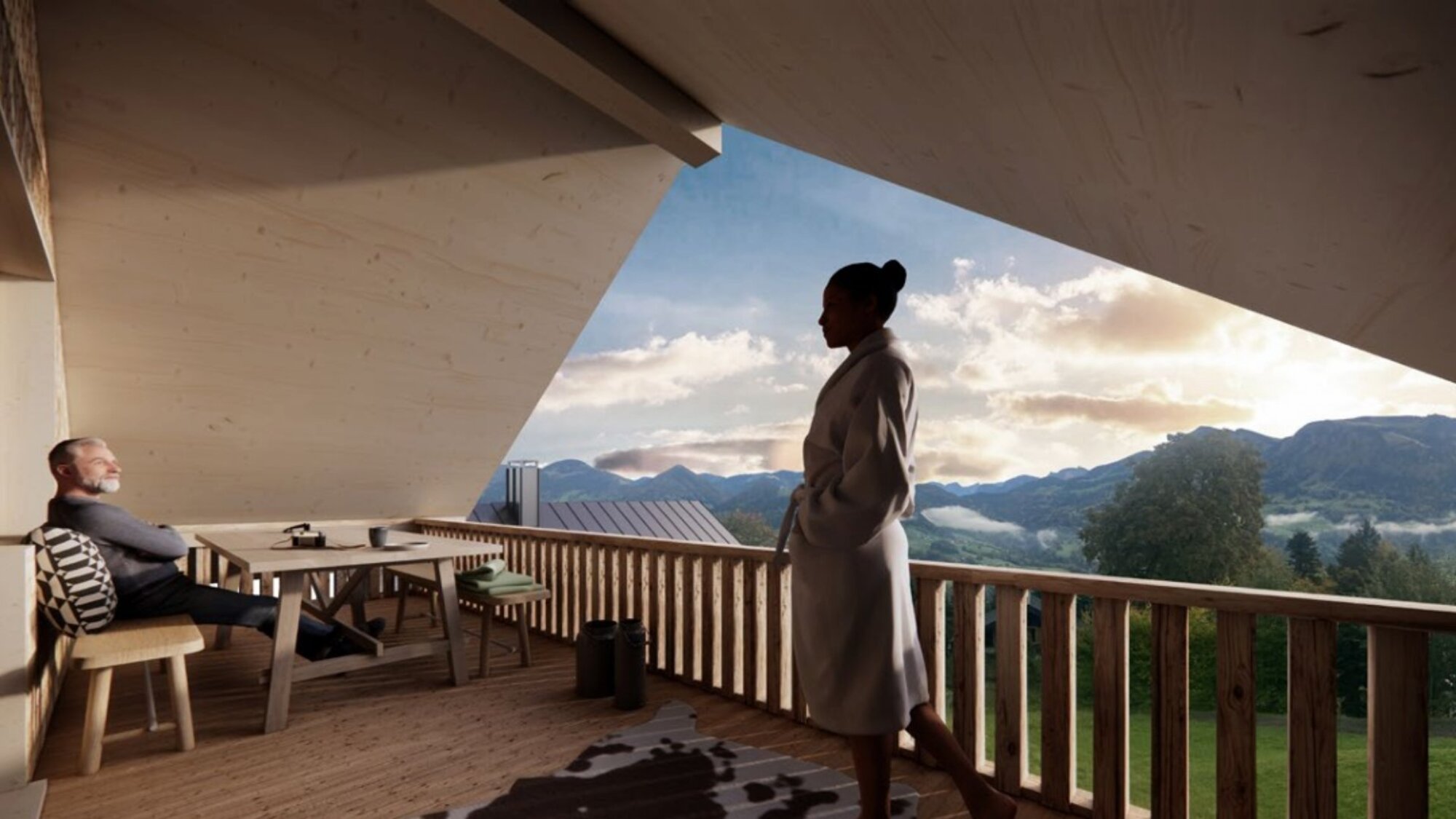 Frau und Mann auf dem Balkon des Ferienchalets mit Bergblick im Abendlicht in Egg, Vorarlberg